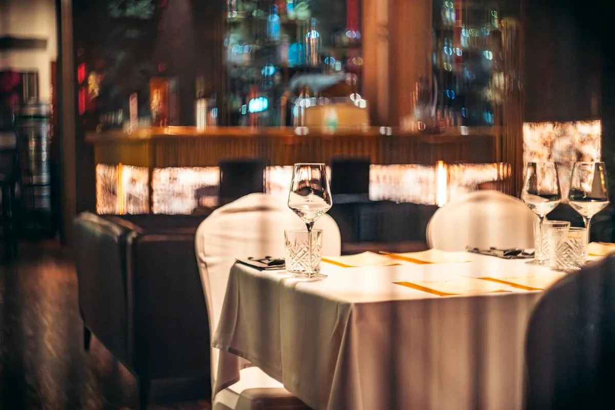 Warmly lit dining table prepared for an evening meal