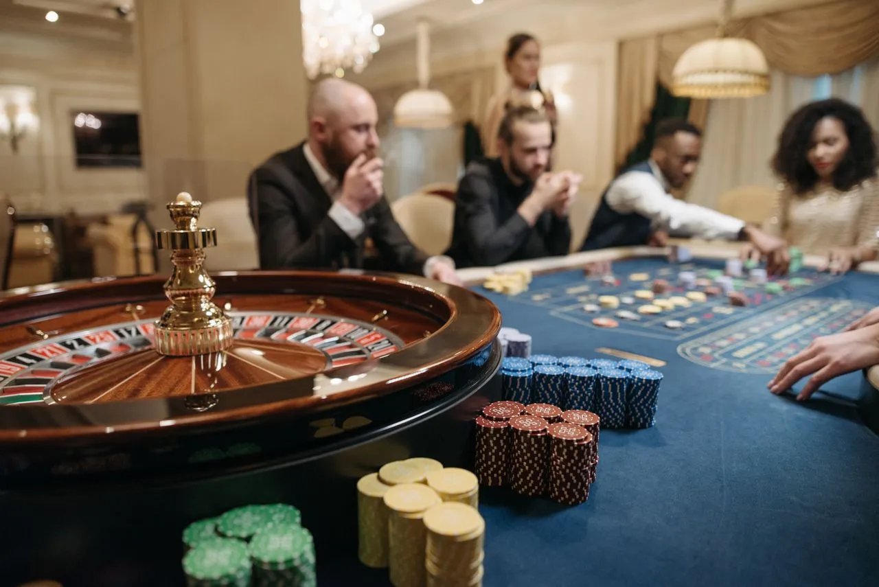 Roulette table with guests seated around it
